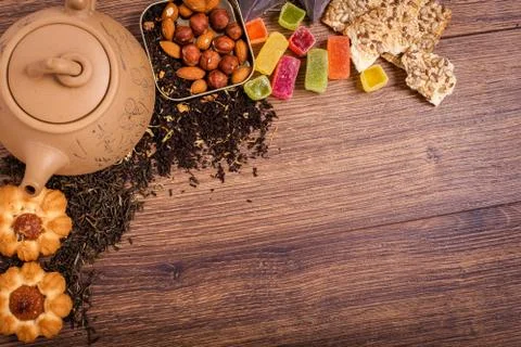 The composition of the tea on a wooden surface. brown teapot from clay with.. Stock Photos