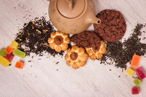 The composition of the tea on a wooden surface. brown teapot from clay with.. Stock Photos