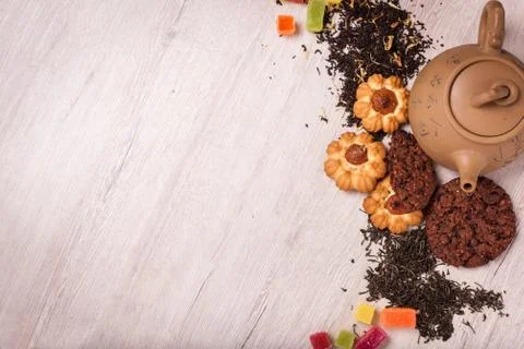 The composition of the tea on a wooden surface. brown teapot from clay with.. Stock Photos