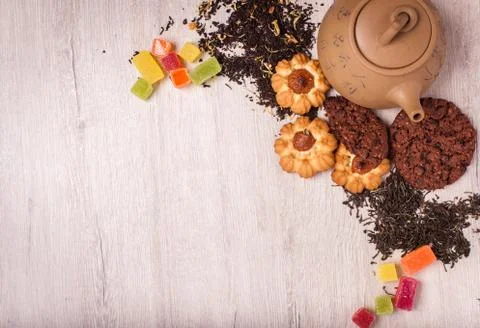 The composition of the tea on a wooden surface. brown teapot from clay with.. Stock Photos