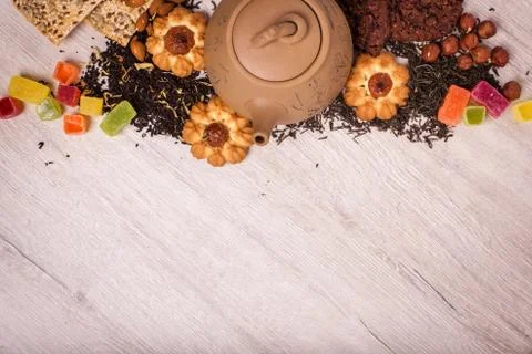The composition of the tea on a wooden surface. brown teapot from clay with.. Stock Photos