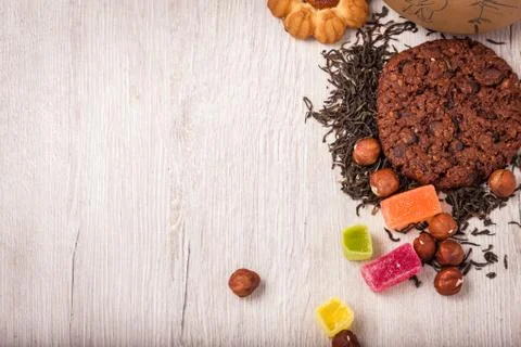 The composition of the tea on a wooden surface. scattering of tea, almond a.. Stock Photos