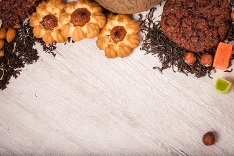 The composition of the tea on a wooden surface. scattering of tea, almond a.. Stock Photos