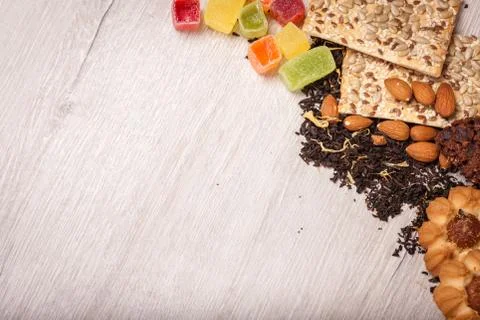 The composition of the tea on a wooden surface. scattering of tea, almond a.. Stock Photos