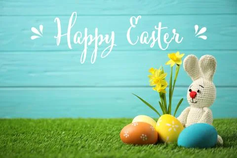 Composition with text Happy Easter and eggs on light blue background Stock Photos