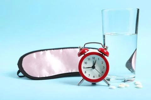 Composition on the theme of insomnia on a colored background Stock Photos