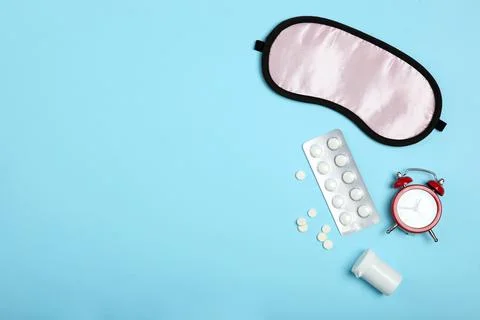 Composition on the theme of insomnia on a colored background Fotos Stock