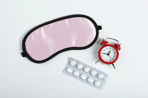 Composition on the theme of insomnia on a colored background Stock Photos