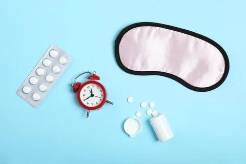 Composition on the theme of insomnia on a colored background Stock Photos