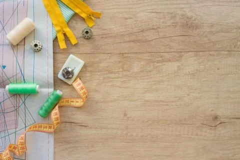 Composition with threads and sewing accessories and tools in green and yellow Stock Photos