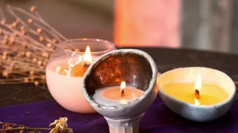 Composition with three homemade burning candles in glass jars on a wooden table Stock Footage 204142150