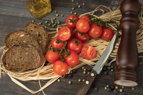 Composition from tomato. Fresh cherry tomatoes on a wooden table with spices. Foto stock