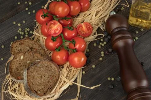 Composition from tomato. Fresh cherry tomatoes on a wooden table with spices. 库存照片