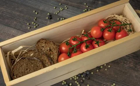 Composition from tomato. Fresh cherry tomatoes on a wooden table with spices. Stock Photos