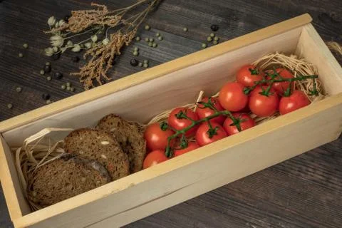 Composition from tomato. Fresh cherry tomatoes on a wooden table with spices. Stock Photos