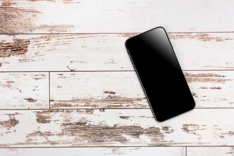 Composition top view on wooden table with modern mobile phone. mock up, empty Stock Photos