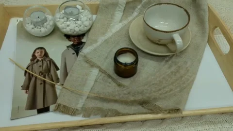 Composition on a tray, fabrics, candles, a magazine, stones and grass Stock Footage 168472575