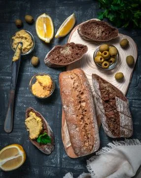 A composition of two baguettes of bran and whole grain flour. Sandwich of hum Stock Photos