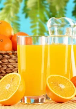 Composition with two glasses of orange juice and fruits Stock Photos