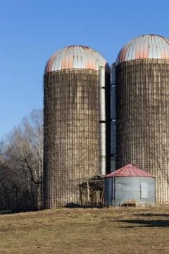 Composition of two large and one small silo in a winter landscape Stock Photos