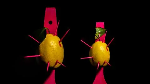 Composition with two lemons and arrows on a black background Stock Photos