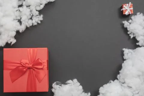 Composition with two red gift boxes of different sizes and a white fiberfill Stock Photos