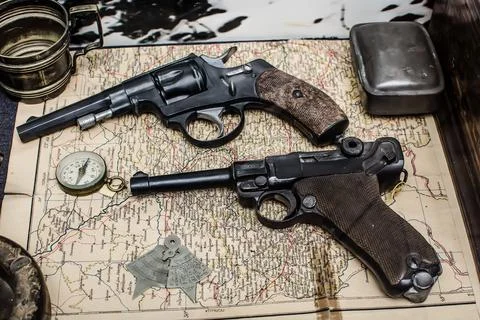 Composition of two revolvers on the map Stock Photos