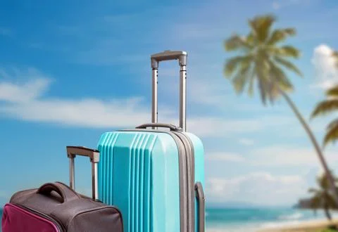 Composition with two suitcases on the background of tropic beach Stock Photos