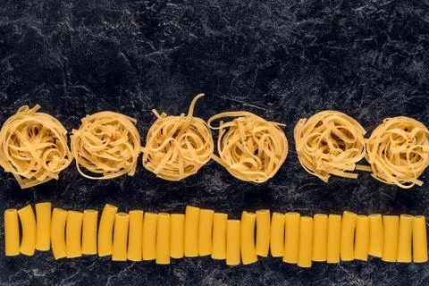 Composition of two types of pasta on black concrete table Stock Photos