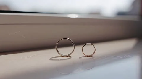Composition of two wedding golden rings at the flat surface. The rings are Stock Footage 134612713