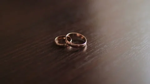 Composition of two wedding rings on the wooden table Stock Footage 123003530