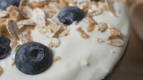 Composition of a typical genuine breakfast made with yogurt, blueberries, muesli Video stock 104894137