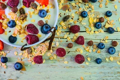 Composition of a typical genuine breakfast made with yoghurt, blueberries, ra Stock Photos