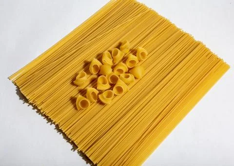Composition of undigested macaroni pasta made with hard light on a white Stock Photos
