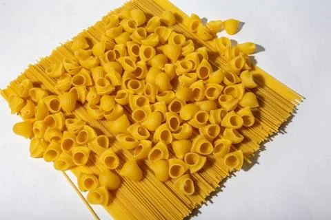 Composition of undigested macaroni pasta made with hard light on a white Stock Photos