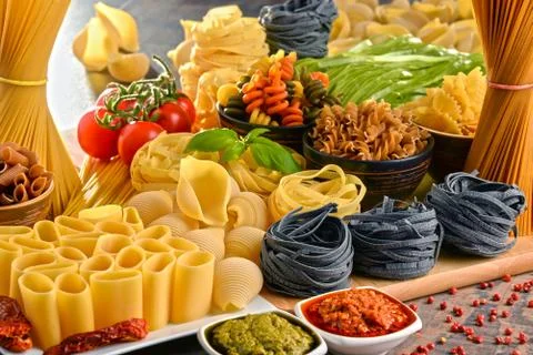 Composition with variety of pasta on kitchen table. Stock Photos