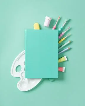 Composition of various art and drawing supplies in pastel colors on a turqu.. Stock Photos