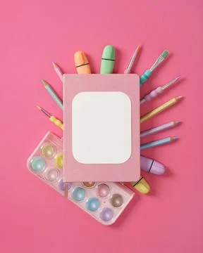 Composition of various art and drawing supplies in pastel colors on pink back Stock Photos