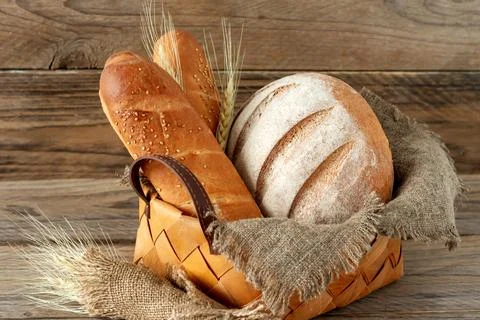 Composition of various baked products in basket on rustic background. Homem.. Stock Photos