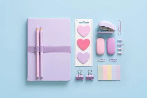 Composition of various school and office stationery in pastel pink and purple Stock Photos