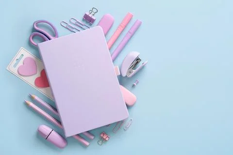 Composition of various school and office stationery in pastel pink and purple Stock Photos