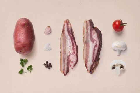 Composition of vegetables with bacon on a beige background Stock Photos
