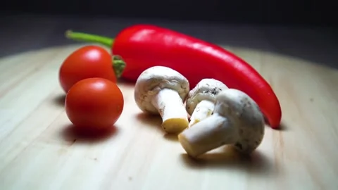 Composition of vegetables rotates on a wooden board. Stock Footage 169464321