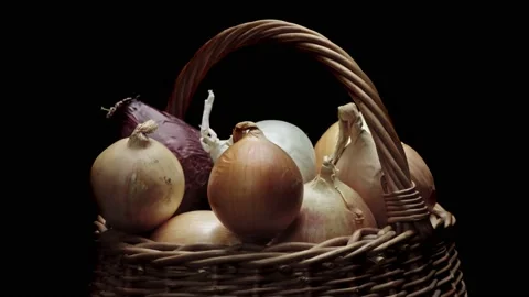 Composition of vegetables, rotation of a basket with onions on a black backgr Stock Footage 150199718