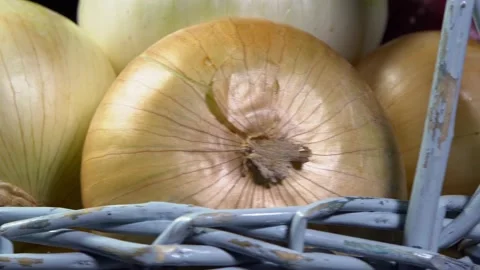 Composition of vegetables, rotation of a basket with onions on a black backgr Stock Footage 165077393
