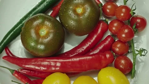 Composition of vegetables, rotation of a white plate with pepper and tomatoes Stock Footage 148535885