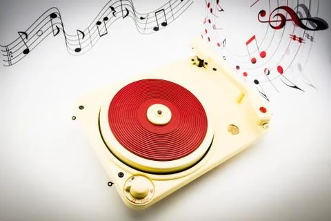 Composition with vintage red record player and musical notes Stock Photos