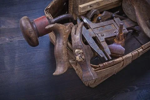 Composition of vintage rusty tools in wicker box building concept Stock Photos