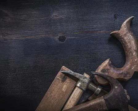 Composition of vintage square ruler rusted claw hammers hand saw Stock Photos
