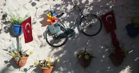Composition on the wall with a bicycle, a Turkish flag and a rainbow spinner Stock Footage 222955723